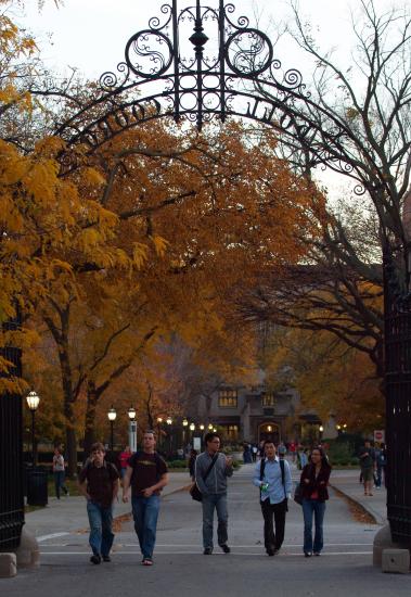 A view of students passing under Hull gate in autumn
